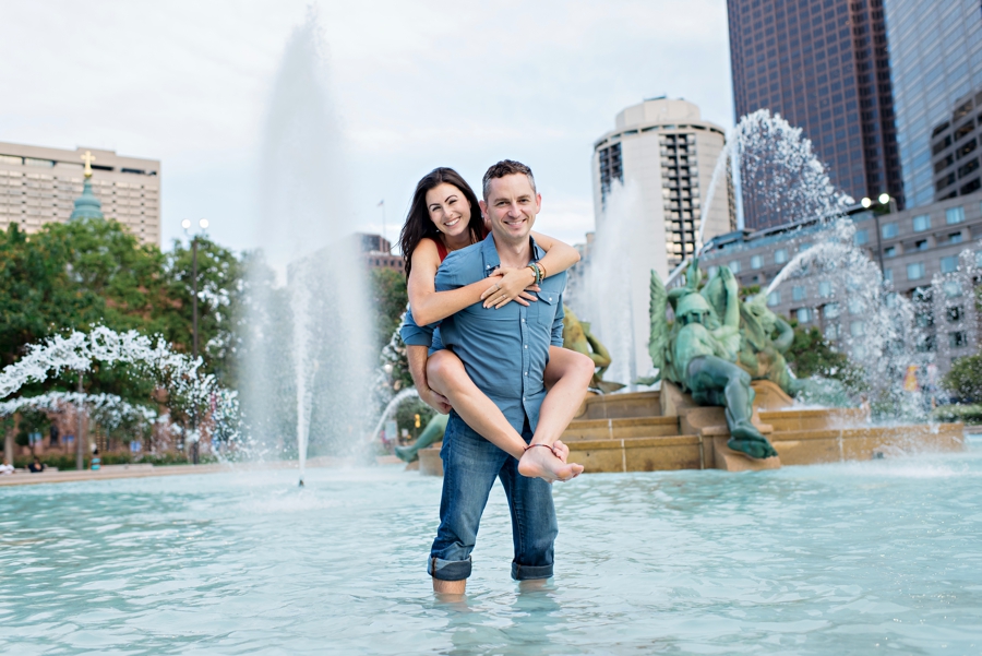 A man carries his fiance through the fountain at Logan Circle in Philadelphia.